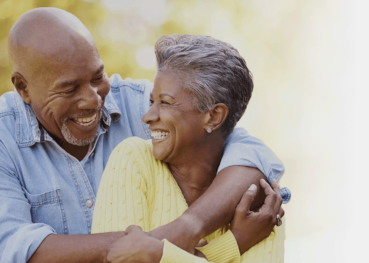 Couple smiling after successful bone grafting treatment