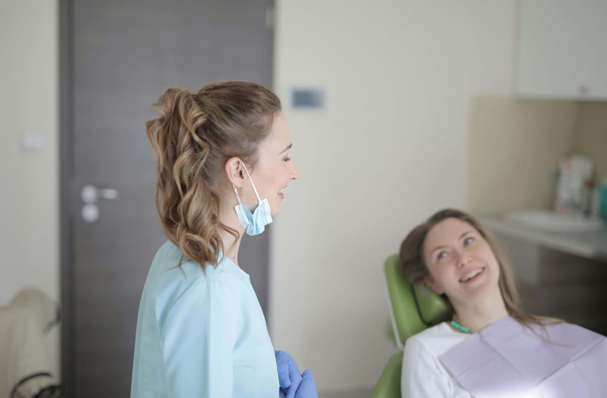 Dental professional with smiling patient during wisdom teeth consultation